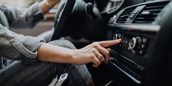 Driver presses buttons on car console