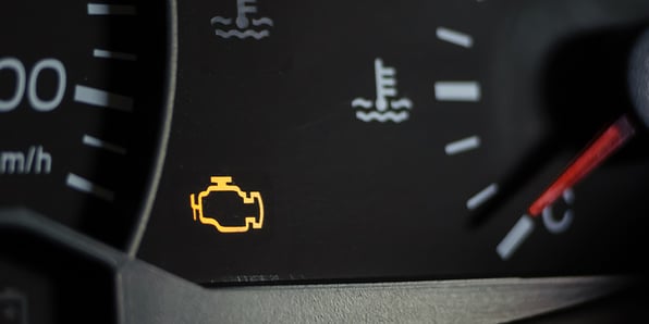 The engine light of a vehicle dashboard is lit up.