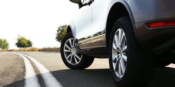 side image of a parked car on a road 