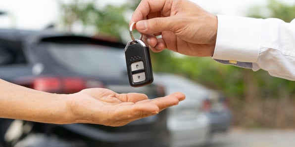 two-hands-one-giving-car-key-fob